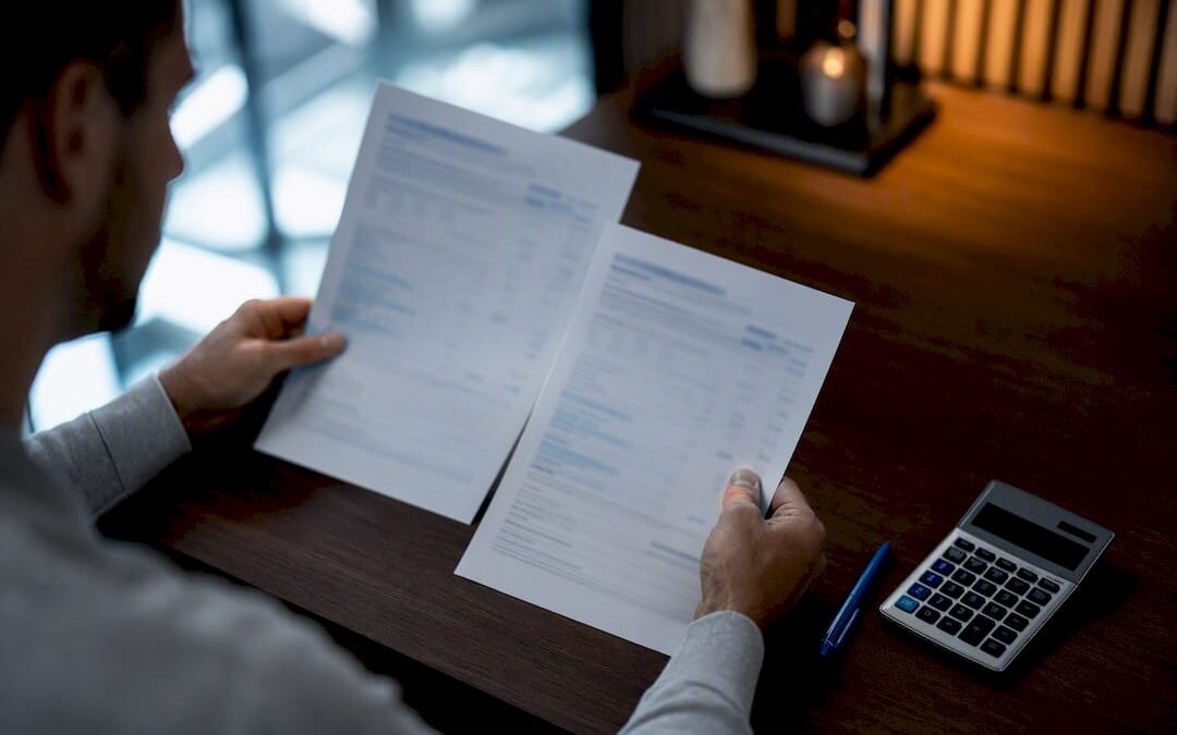 Hands comparing life insurance policy options